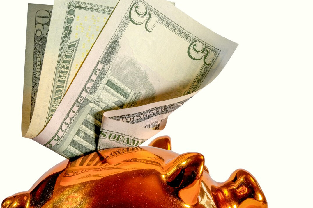 person depositing money in bank
