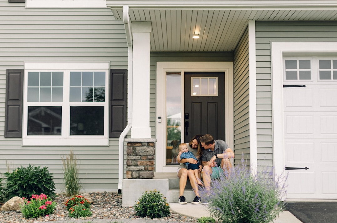 family protecting home with insurance