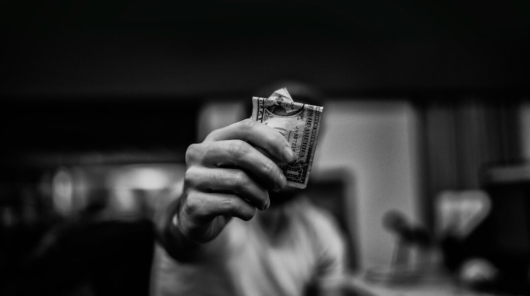 person depositing money in bank